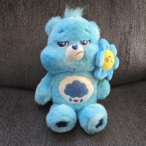 Care Bears Grumpy Bear Holding A Blue Flower 2025 Dan Dee